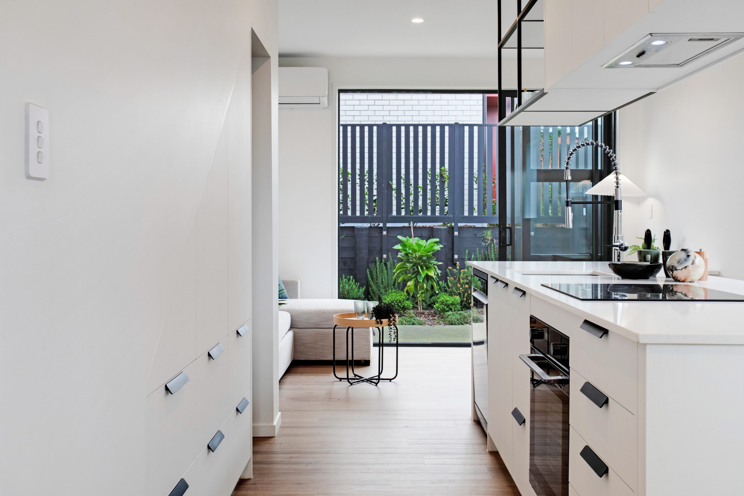 Kitchen shot leading through lounge and outdoor patio 