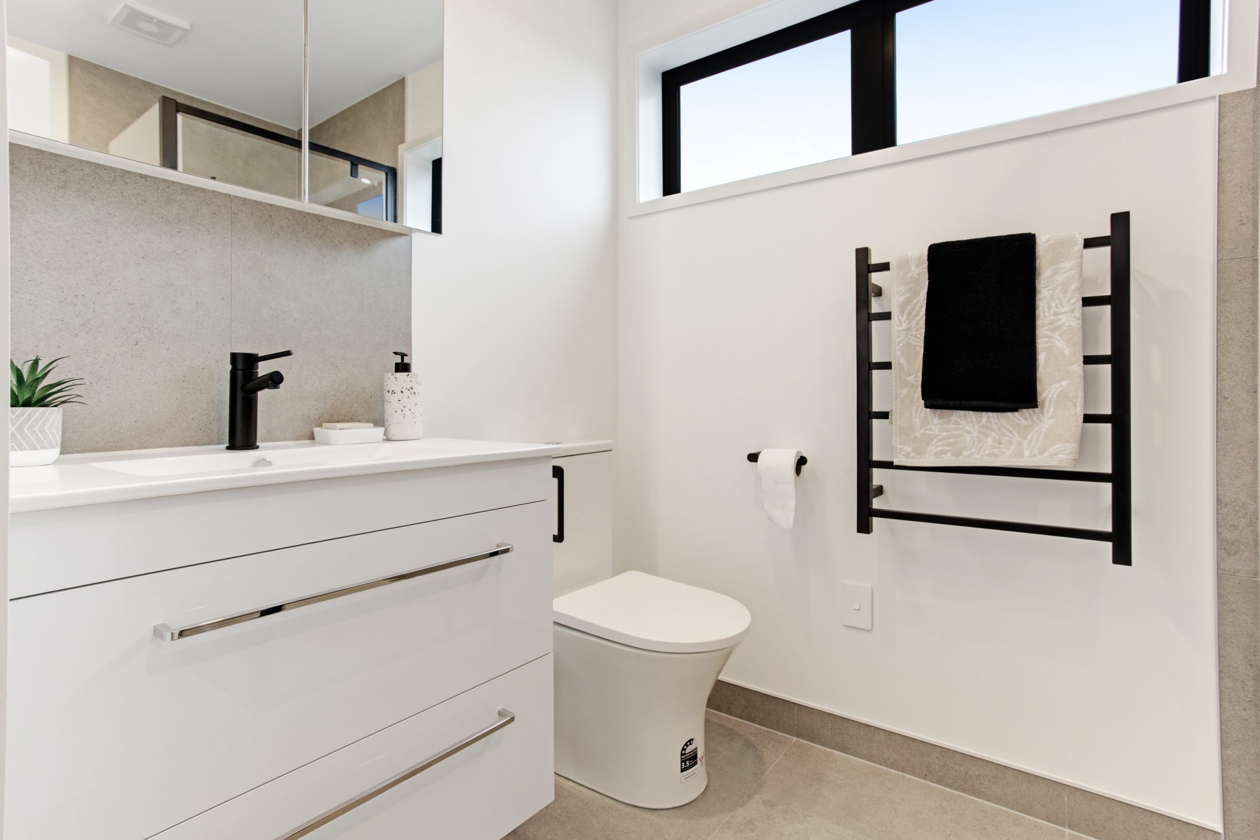 Bathroom with toilet, shower and vanity. 
